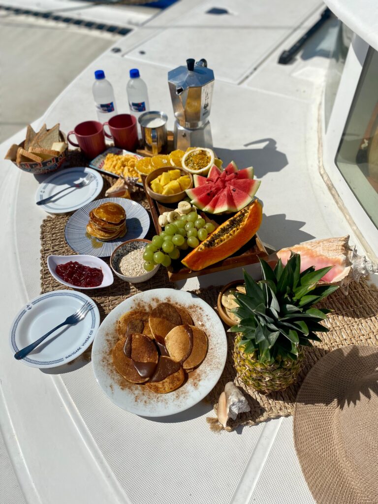 A vibrant platter of fresh-sliced pineapple, papaya, and passionfruit, served with yogurt and local Panamanian coffee.