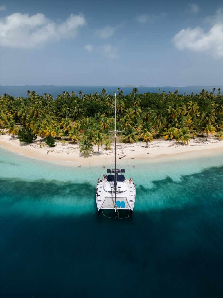 A stunning, aspirational photo of the Nomade anchored all alone in a remote, pristine, and "nameless" cay in the Holandeses