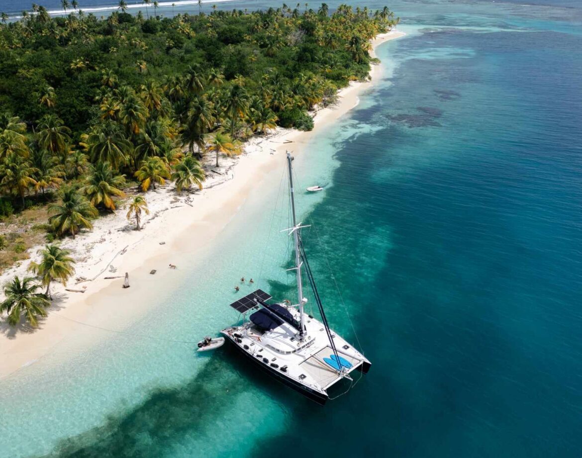 A stunning, aspirational photo of the Nomade anchored all alone in a remote, pristine, and "nameless" cay in the Holandeses