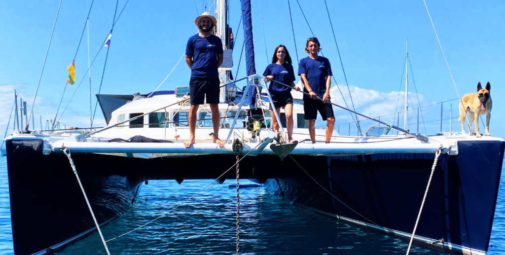 A beautiful, professional photo of the Nomad Sailors Crew at anchor, looking safe, modern, and reliable