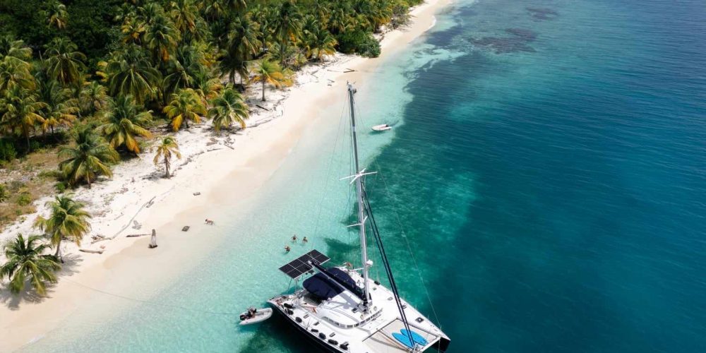 A stunning, aspirational photo of the Nomade anchored all alone in a remote, pristine, and "nameless" cay in the Holandeses